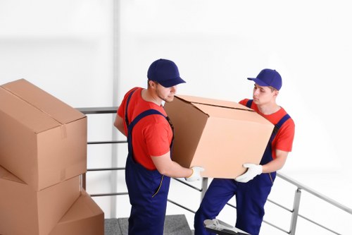 Professional movers transporting furniture through a Tufnell Park property