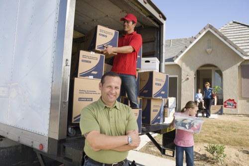 Packed boxes and furniture ready for loading into a van