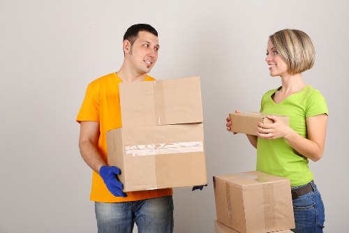 Professional movers handling office furniture and IT items