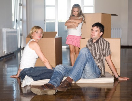 Professional movers organizing furniture and fragile items during a move